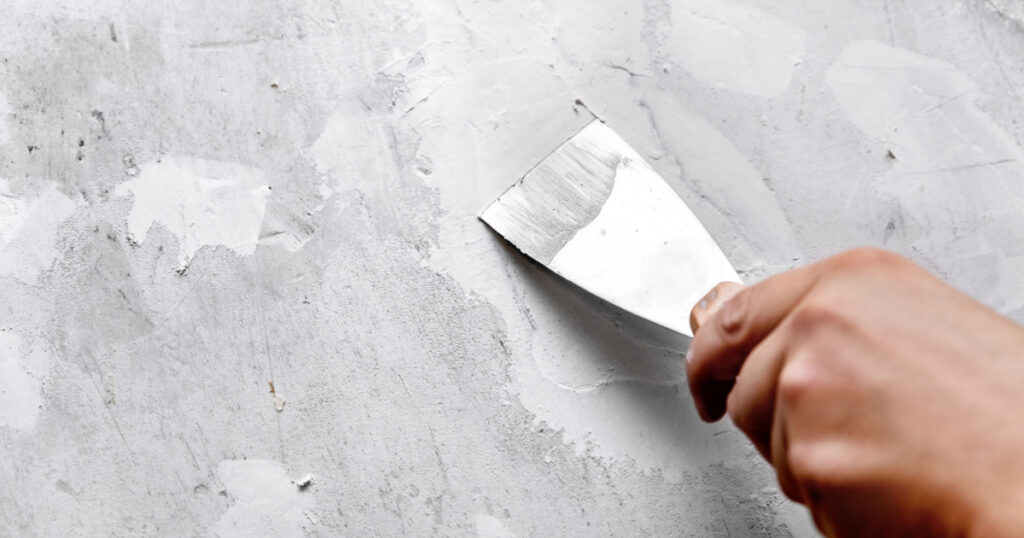 Holes and cracks in a wall are filled with filler or gypsum