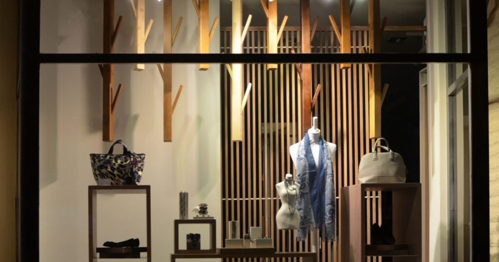 Boutique window with shoes, bags and mannequin