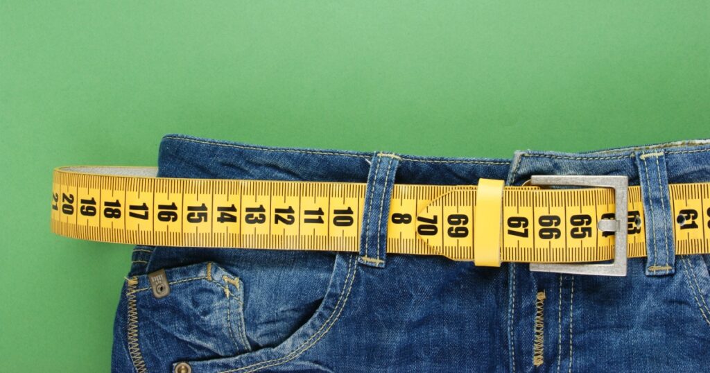 jeans with meter belt slimming on the green background