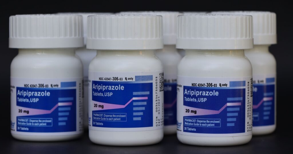 COLUMBUS, GEORGIA/ USA - 08-27-2020 Bottles of Aripiprazole against black backdrop.