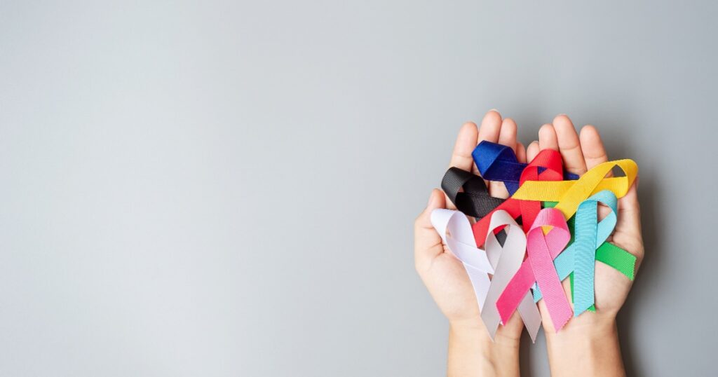 World cancer day (February 4). colorful awareness ribbons; blue, red, green, black, grey, white, pink and yellow color for supporting people living and illness. Healthcare and medical concept