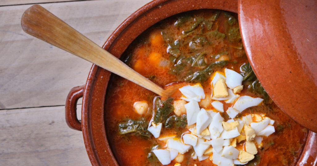 earthenware casserole with spinach chickpea and hard-boiled egg stew