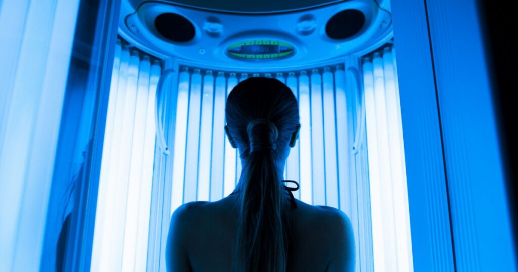 pretty woman or cute girl with sexy naked healthy body standing in solarium spa salon