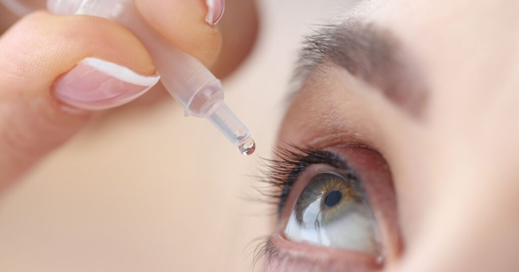 Woman drips eye drops into her eyes. Eye diseases and their treatment concept