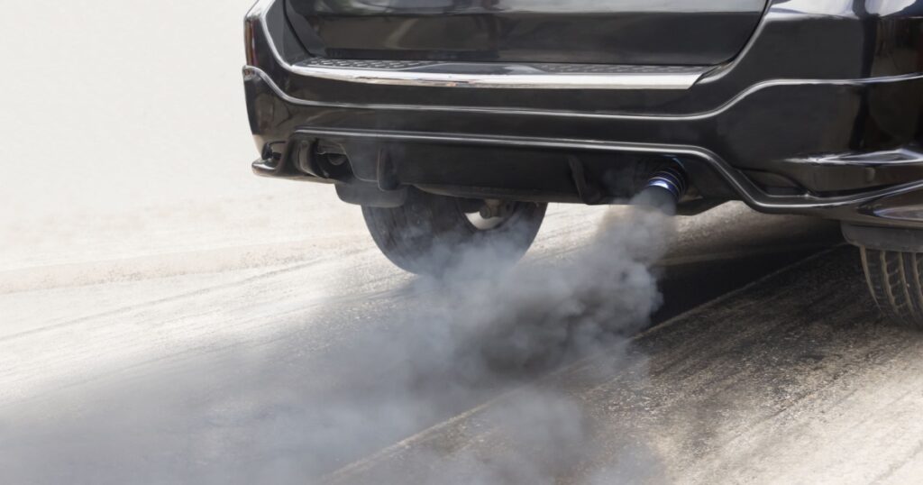 air pollution crisis in city from diesel vehicle exhaust pipe on road