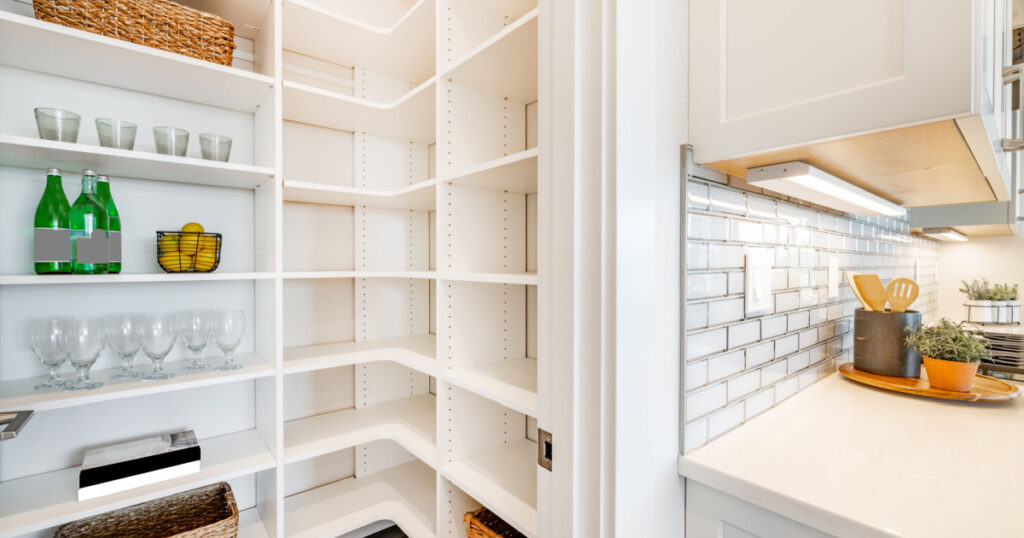 pantry and mudroom with white walls shelving hardwood floor