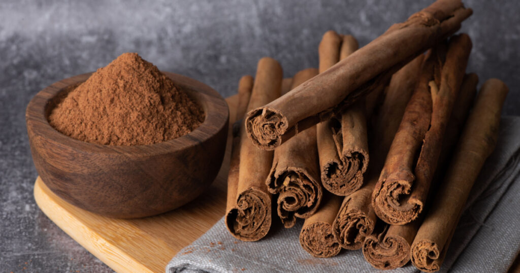 Cinnamon sticks on a wooden background. Cinnamon spice in a spoon and bowl. Ceylon cinnamon.