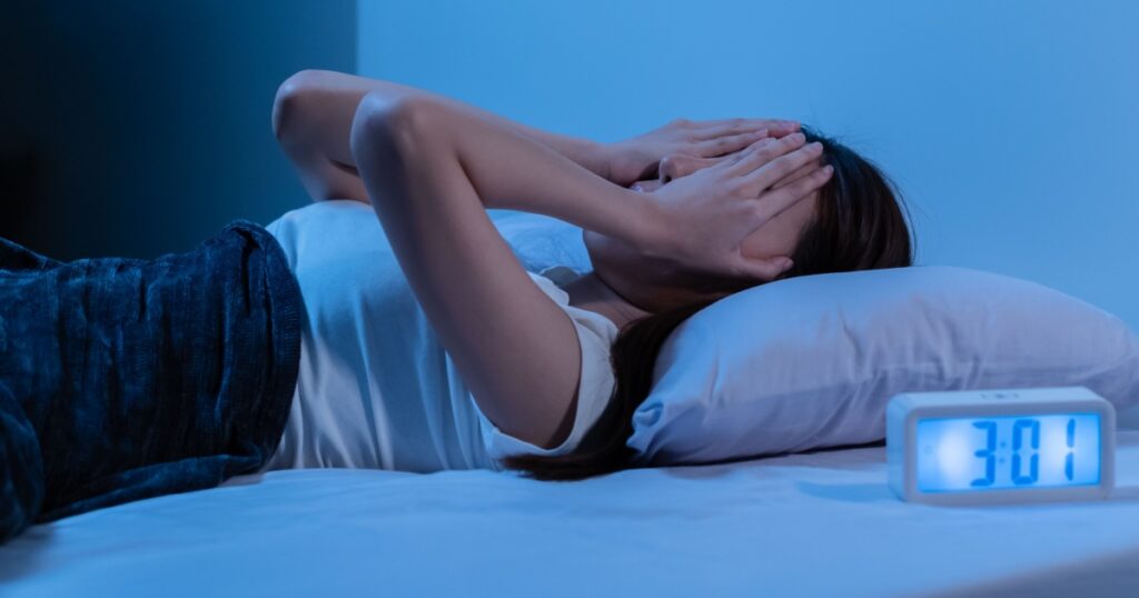 Annoyed, Stressed, asian young beautiful, pretty woman, girl suffering from insomnia, awake in bed at night, covering face with hand because of disturbed loud noise, unable sleep. Restless people.