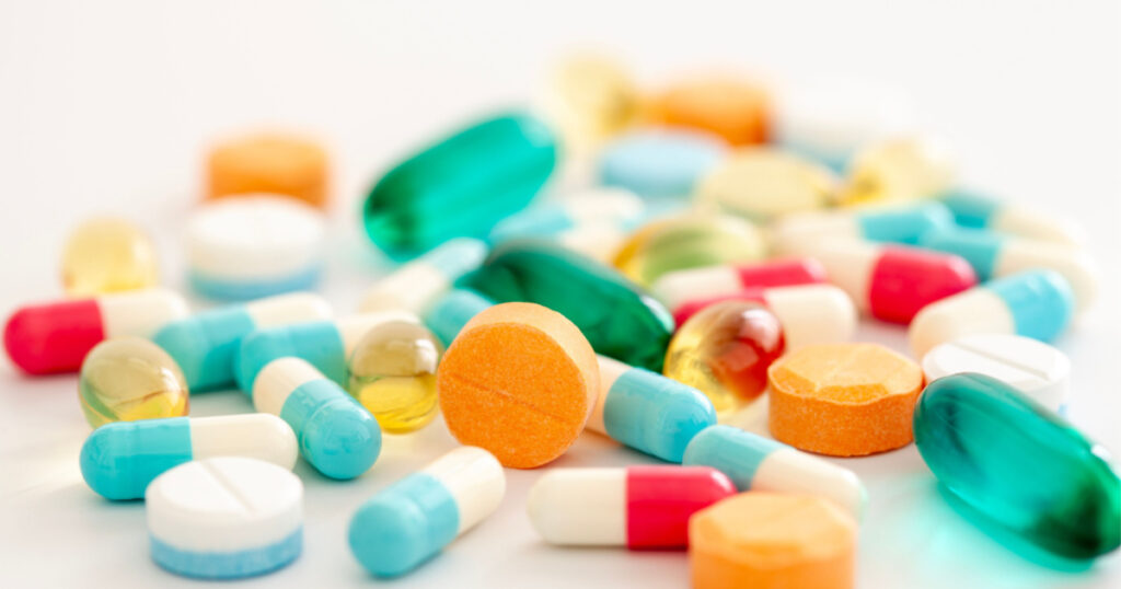 Pills, different colors, with selective focus.