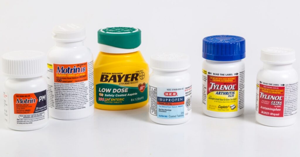 LLANO, TEXAS-Jan 09, 2015: Assortment of pain relief medication and heart healthy low dose aspirin on neutral background with copy space.