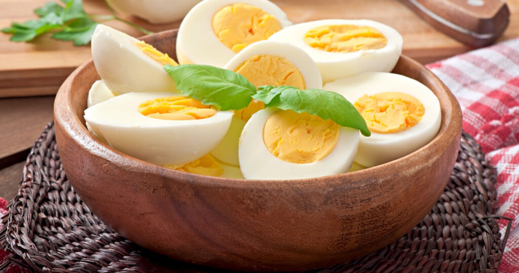 Boiled eggs in a bowl decorated with parsley leaves