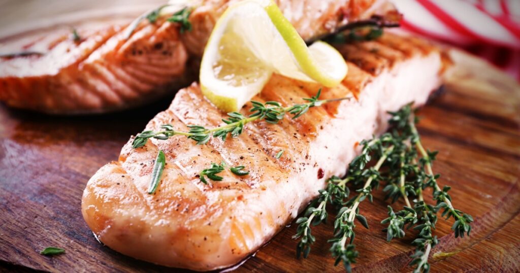Grilled salmon on cutting board close-up