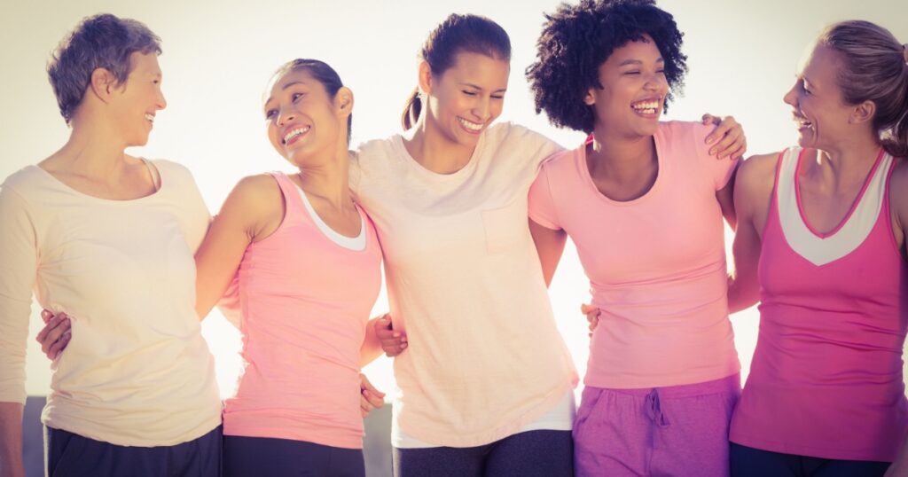 Laughing women wearing pink for breast cancer in parkland