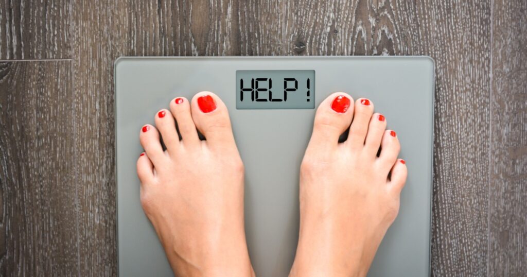 Lose weight concept with person on a scale measuring kilograms
