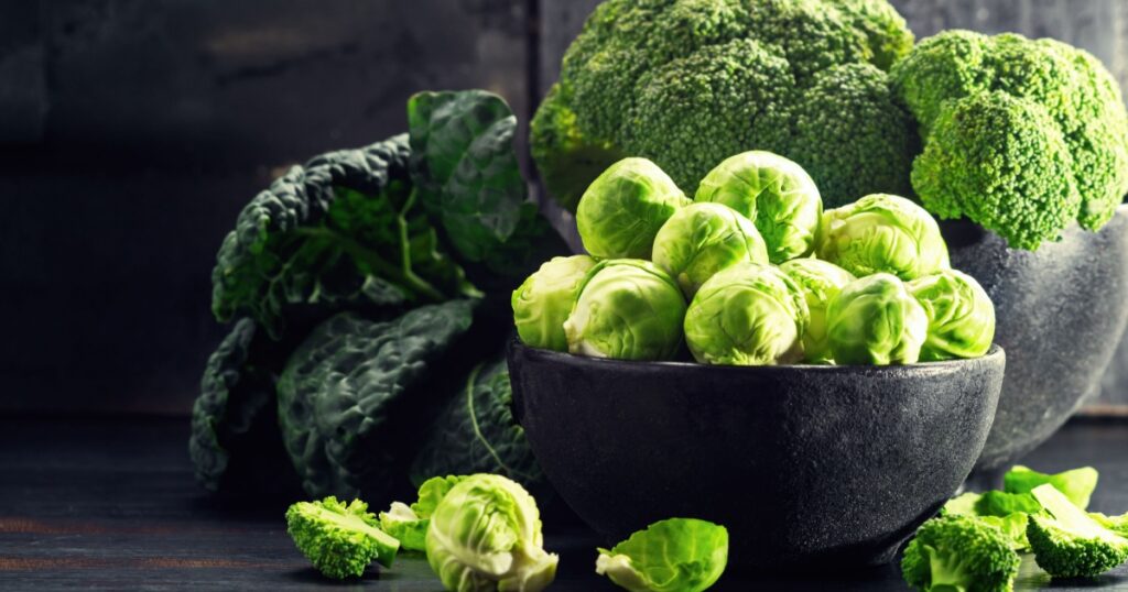 Brussels Sprout with Broccoli, kale, and on black wooden table. Selective focus.