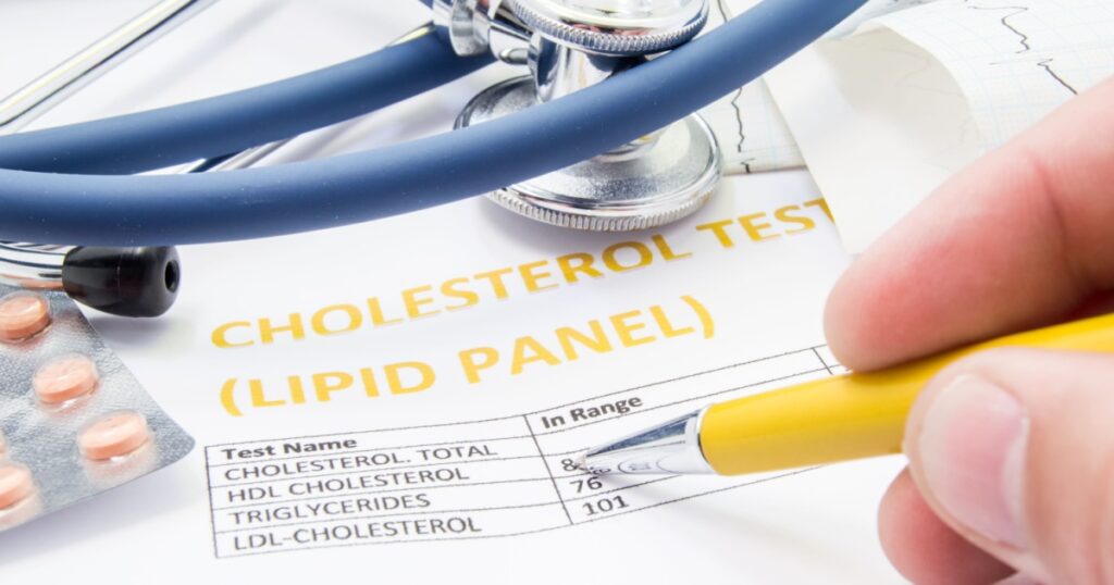 General practitioner checks cholesterol levels in patient test results on blood lipids. Statin pills, stethoscope, cholesterol test and hand of doctor, pointing to increasing its level in concept