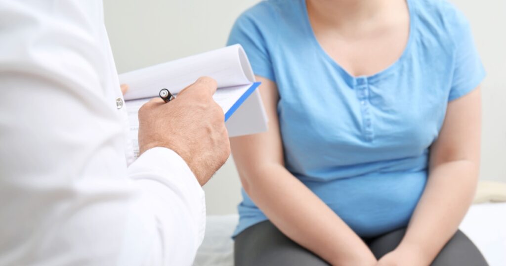 Overweight woman discussing test results with doctor in hospital