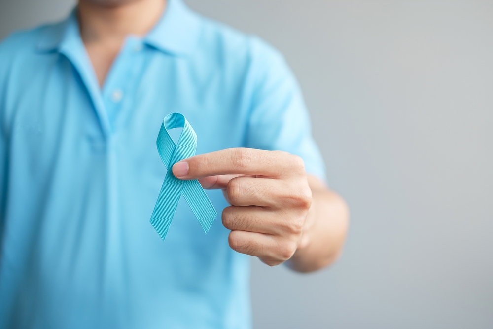 November Prostate Cancer Awareness month, Man in blue shirt with hand holding Blue Ribbon for supporting people living and illness. Healthcare, International men, Father and World cancer day concept
