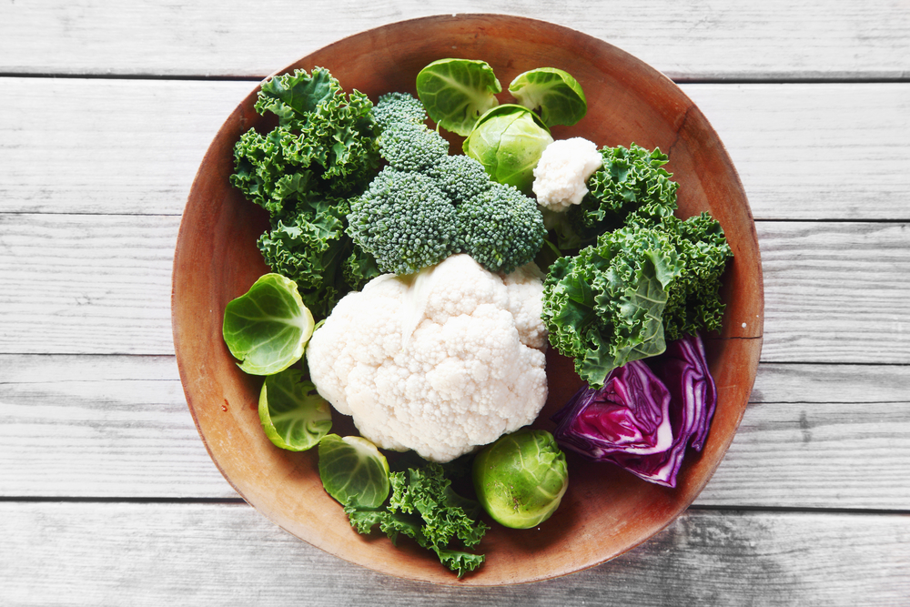 Close up Healthy Fresh Salad Ingredients with Broccoli, Cauliflower, Purple Cabbage and Brussels Sprout on Wooden Bowl, Placed on Wooden Table.
