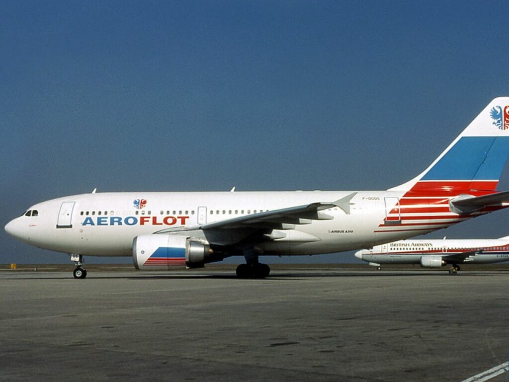 Aeroflot plane with a British airways plane, tarmac, and sky in the background. 