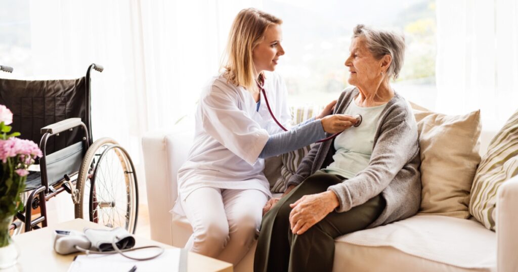 Health visitor and a senior woman during home visit.