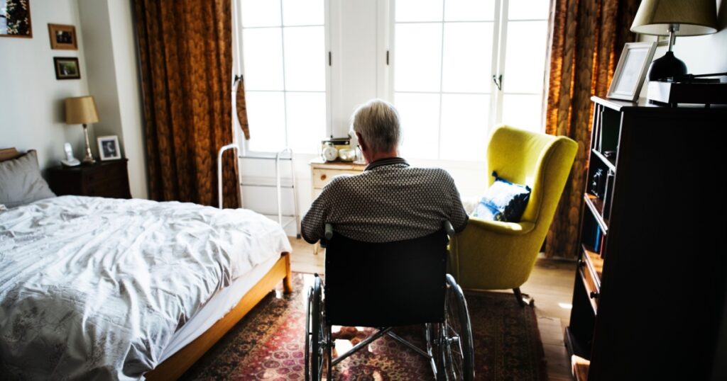 Senior man sitting on the wheelchair alone