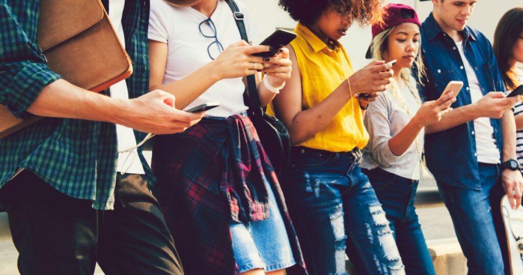 Diverse friends using their phones
