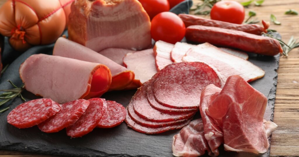 Assortment of delicious deli meats on slate plate