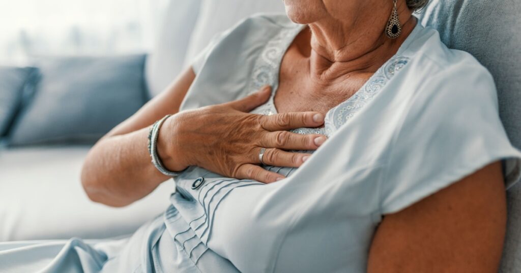 Woman having a pain in the heart area. Heart Attack. Painful Chest. Health Care, Medical Concept. High Resolution. Woman having heart attack at home