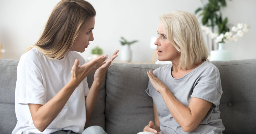 Angry young woman has disagreement with annoyed old mother in law, grown daughter arguing fighting quarreling with senior elderly mom, different age generations bad relations family conflict concept