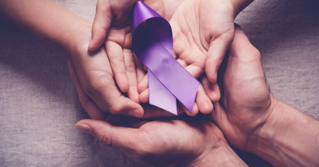 Adult and child hands holding purple ribbons, Alzheimer's disease, Pancreatic cancer, Epilepsy awareness, world cancer day