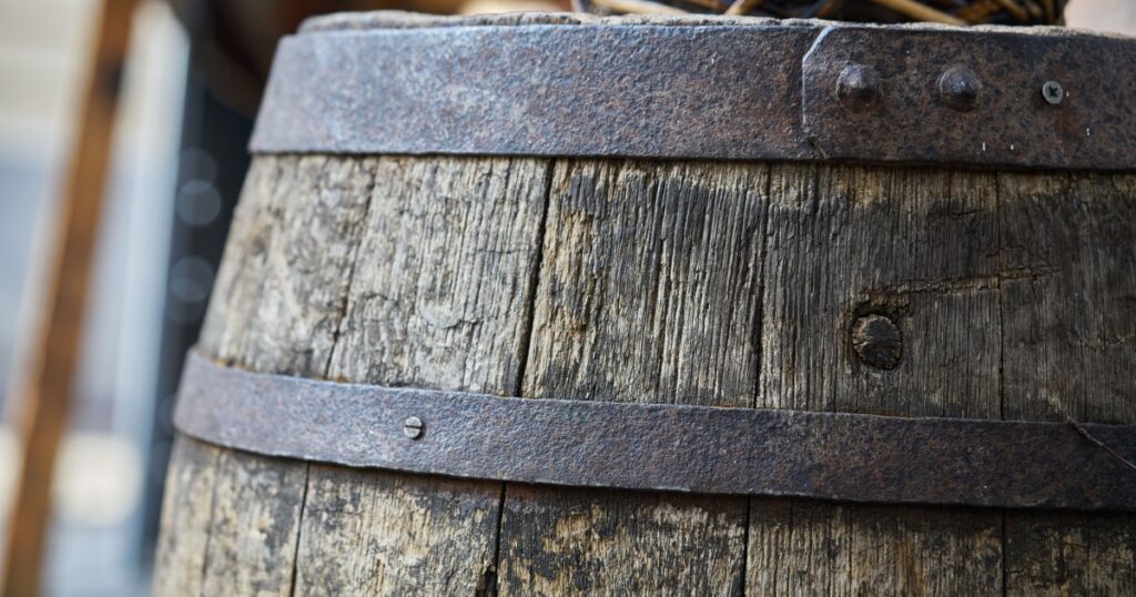 Old wooden barrel on a brown background.