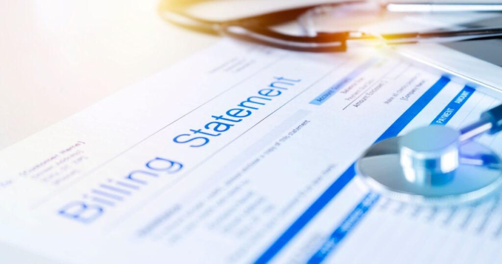 Health care billing statement with stethoscope, bottle of medicine for doctor's work in medical center stone background.