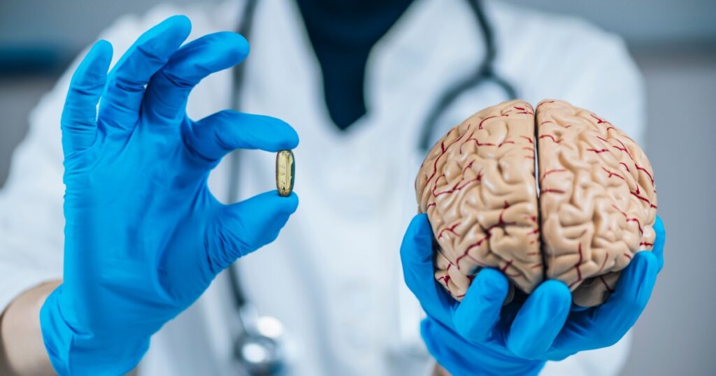 Placebo Effect Concept. Female doctor holding model of brain and placebo supplement pill, explaining the placebo effect healing phenomenon