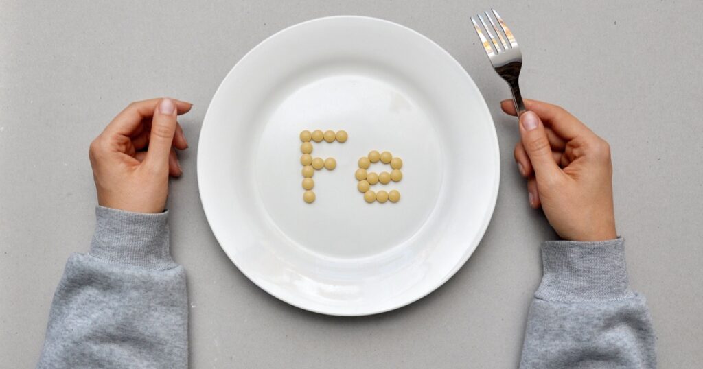 Sign of the trace element "iron" from tablets on a white plate. Iron deficiency in the body