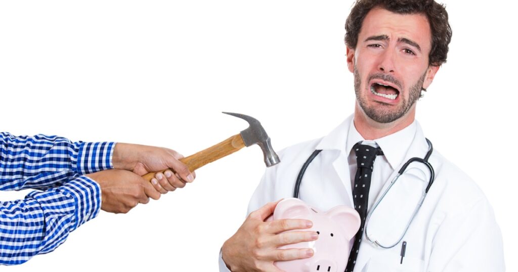 Closeup portrait, male healthcare professional, doctor, nurse with stethoscope protecting piggy bank, someone trying crack open to take out and steal his money, isolated white background.