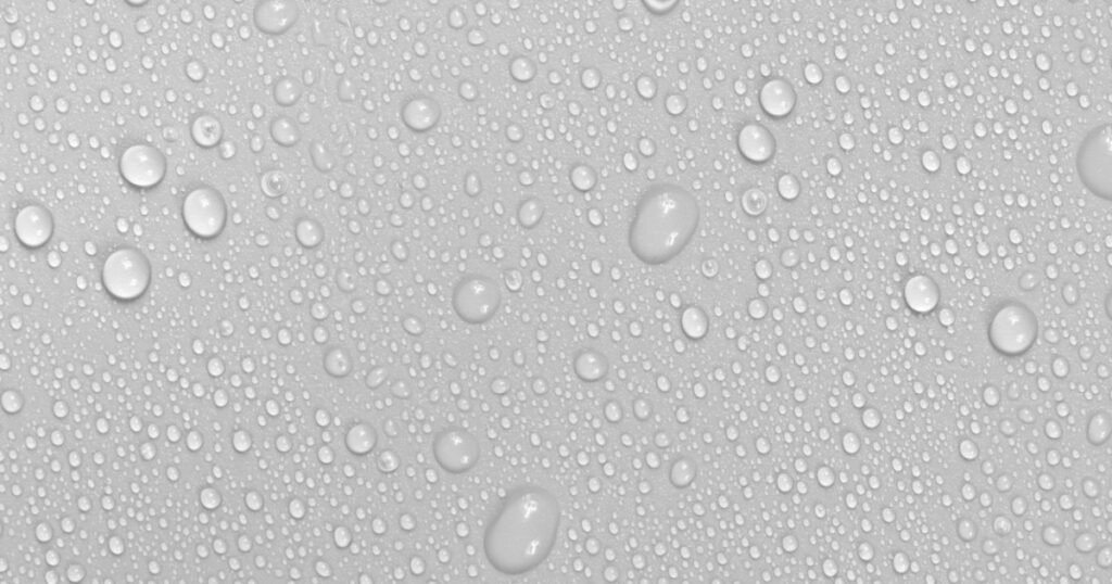 Water drops on white background texture. backdrop glass covered with drops of water. bubbles in water