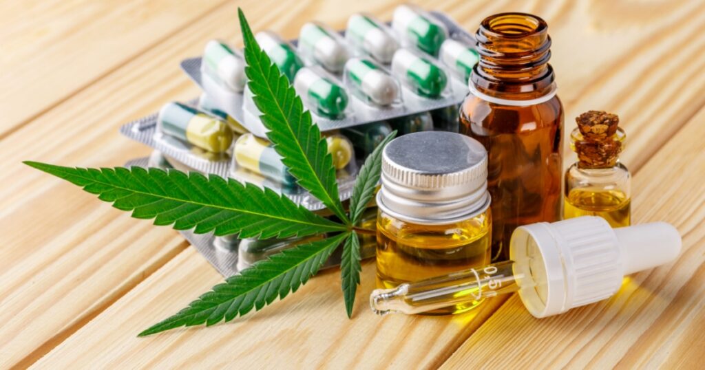Green leaves of medicinal cannabis with extract oil.Medical marijuana flower buds. Hemp buds - medical marijuana concept