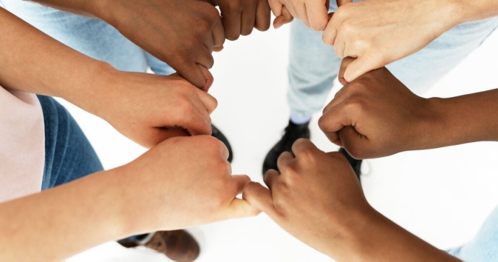 Closeup of different ethnicity female hands. Multicultural diversity and friendship.