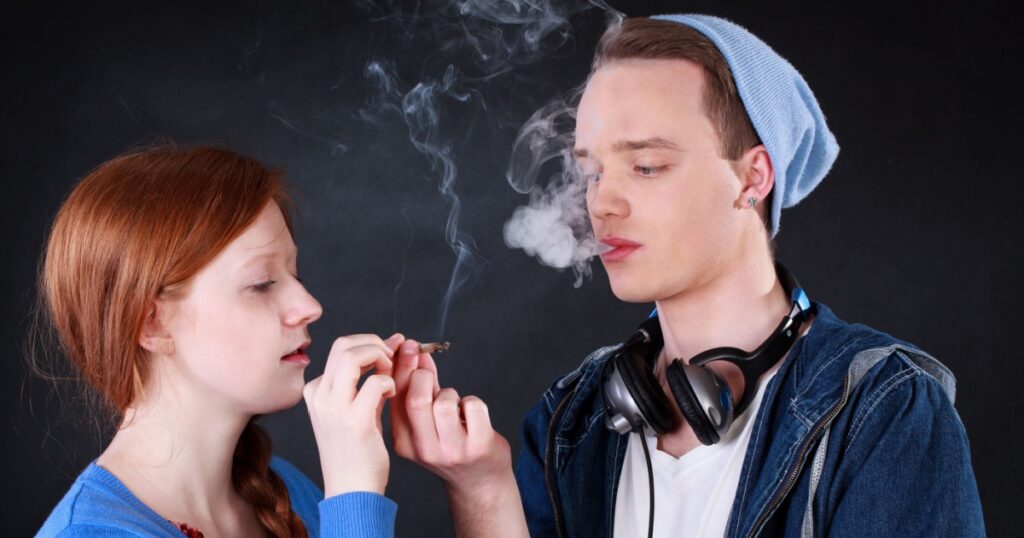 Horizontal view of a teenagers smoking marijuana joint