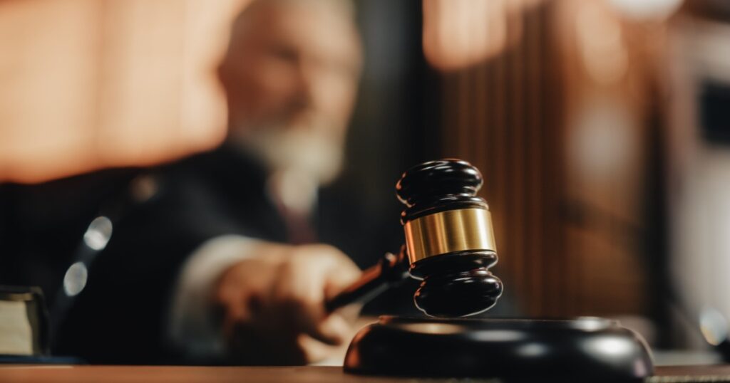 Court of Law and Justice Trial Session: Imparcial Honorable Judge Pronouncing Sentence, striking Gavel. Focus on Mallet, Hammer. Cinematic Shot of Dramatic Not Guilty Verdict. Close-up Shot.