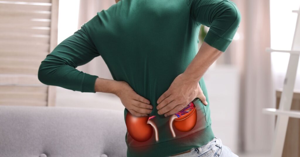 Man suffering from kidney pain at home, closeup