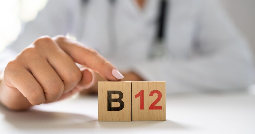 Vitamin B12. Medical Doctor Hand In Hospital