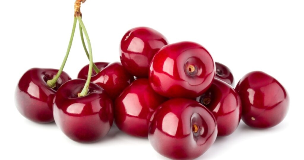 Sweet cherries pile isolated on white background