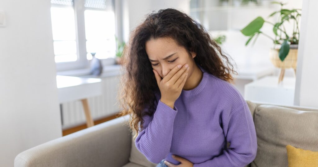 Closeup portrait of Asian unhappy, annoyed, sick woman about to chuck, throw up, puke retch barf. Negative emotions, feelings, facial expressions. Asian woman with morning sickness.