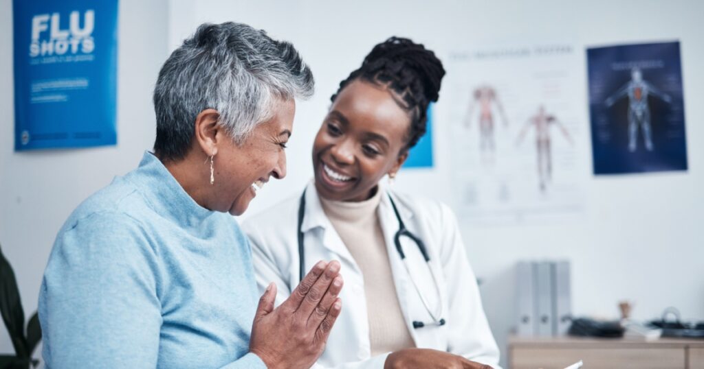 Black woman, doctor and elderly patient with good news, tablet and results for health, advice and report. Happy african medic, mobile touchscreen or healthcare with smile, tech or support in hospital