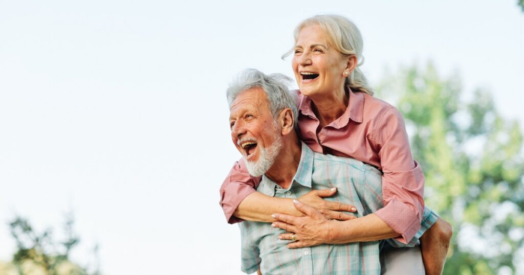 Happy active senior couple having fun outdoors. Portrait of an elderly couple together