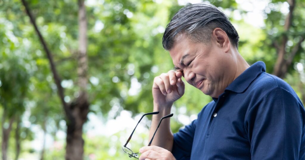 Senior Asian Man holding unfit glasses, Struggling with Eyesight Problem, Eye Health Concept
