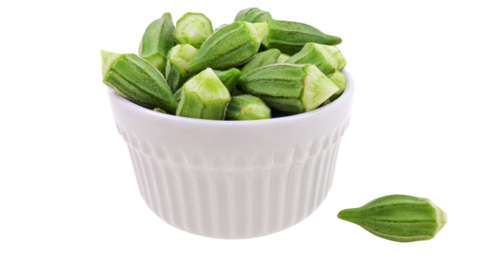 Egyptian okra small size in white bowl ready for cooking isolated on white background top view