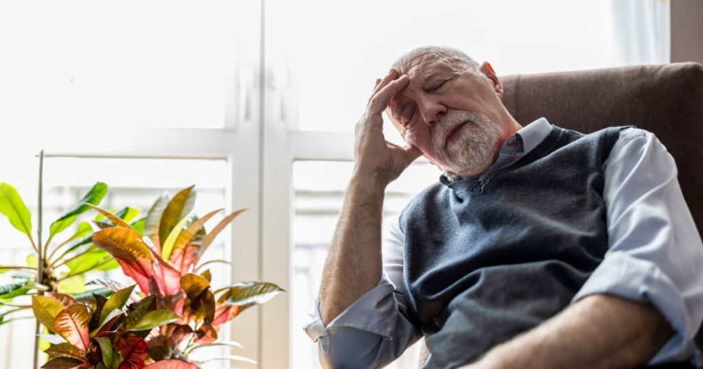 Senior man sleeping in an armchair at home
